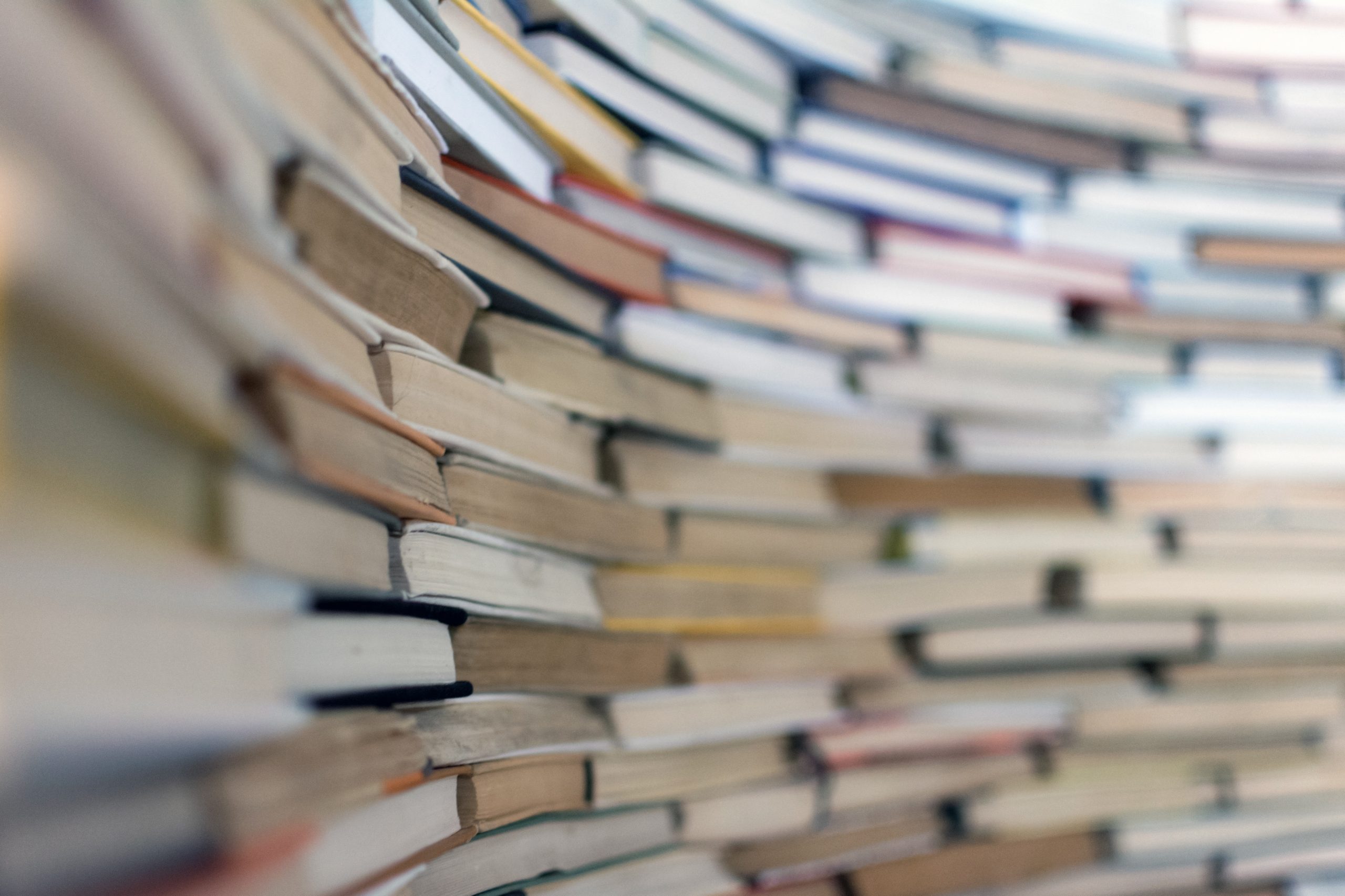 A big pile of books, stacked up to look like a brick wall.