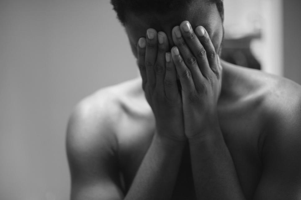 man hiding face with hands