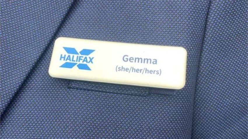 An employee badge attached to a blue blazer. It shows the Halifax logo and reads "Gemma she/her/hers"