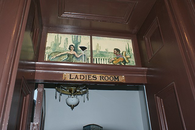 A sign reading "ladies room" above the door to a women's bathroom. This is from The St James Hotel but I imagine its not far off what the signage i...
