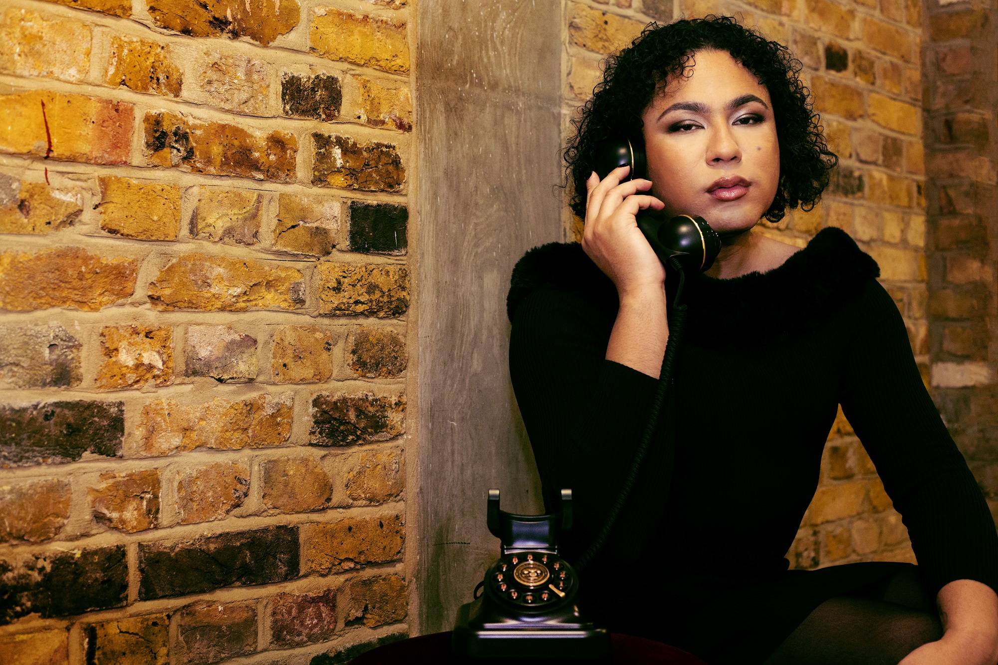 Promotional image for When All Is Said depicting writer and curator Travis Alabanza on the phone