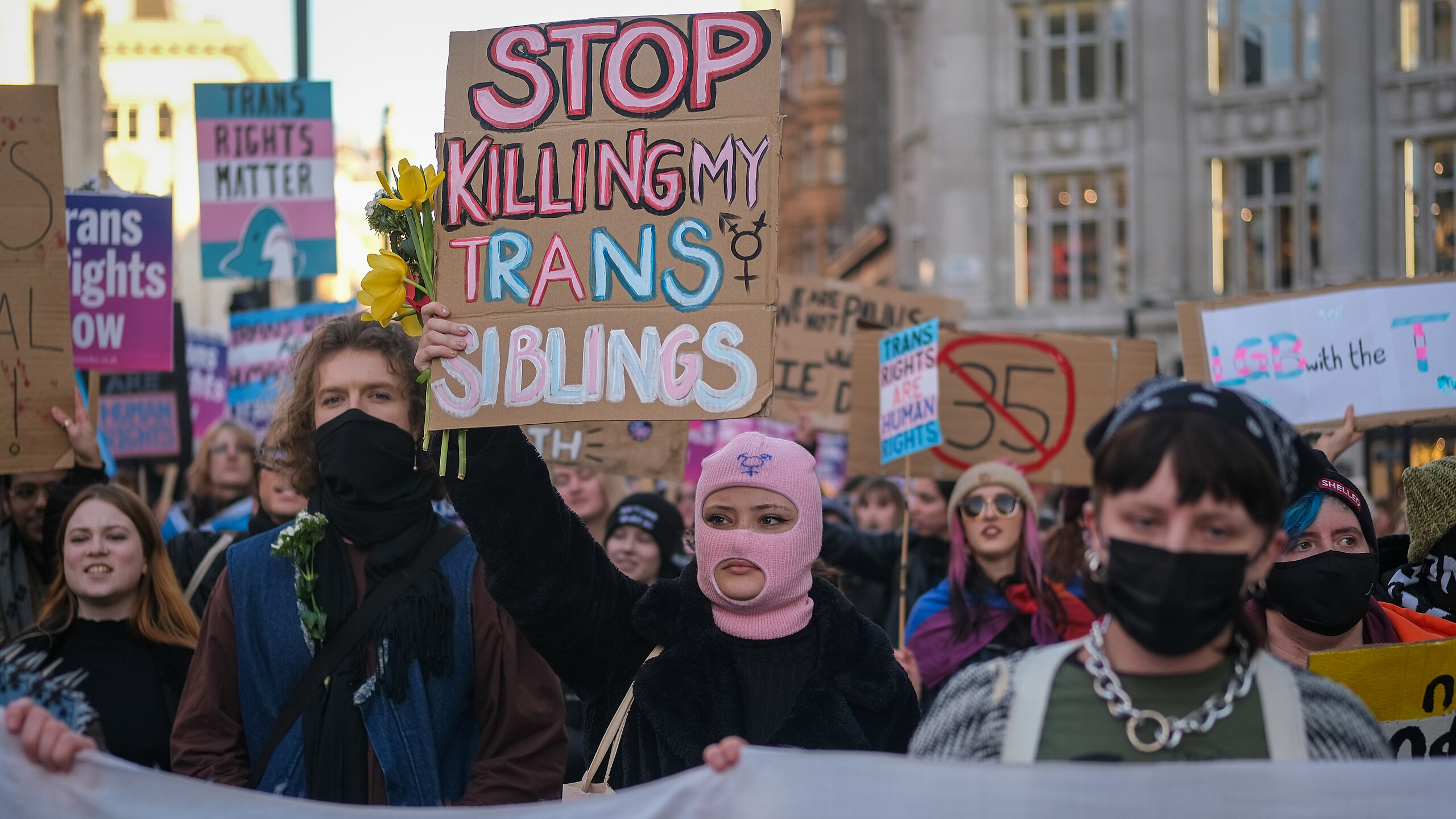 A protestor holds up a sign reading "Stop killing my trans siblings" at protests in London following the UK's decision to block Scottish democracy ...