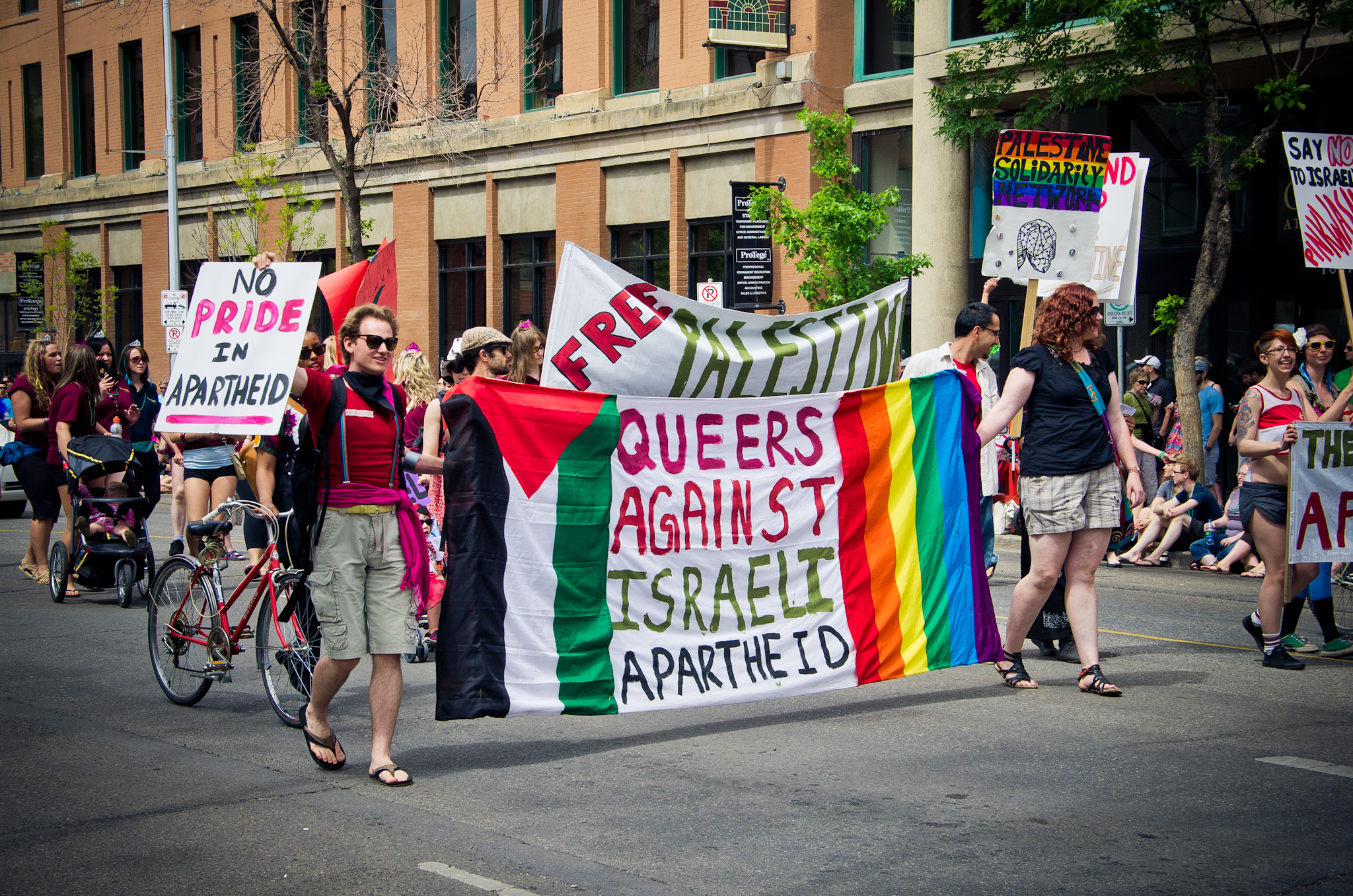 Edmonton Pride Parade 2011 where the "gays for gaza" spirit was alive as queers march holding signs opposing Israeli apartheid in Palestine, photo ...