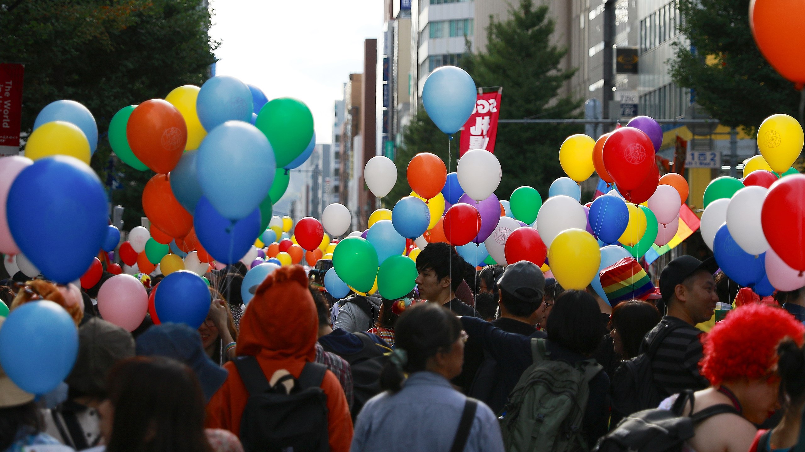 An image from Sapporo rainbow pride in 2019, the same year Law 111 was last upheld in Japan. The Image shows hundreds of people walking below rainb...