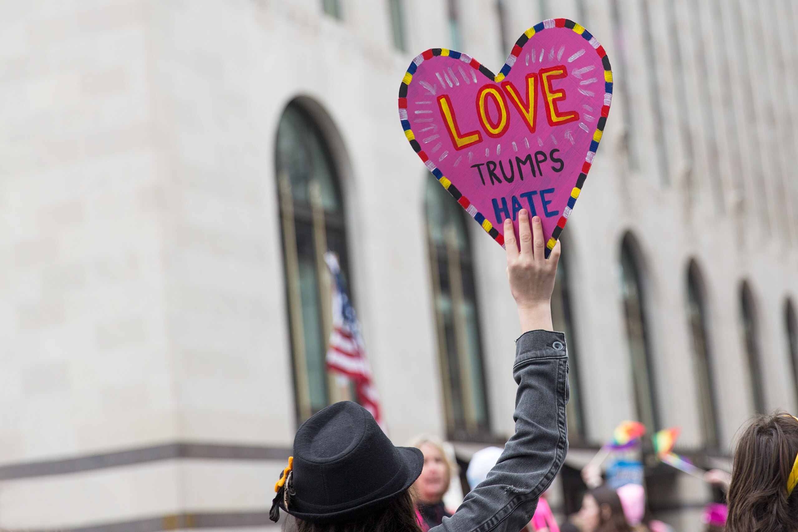My message to LGBTQIA publications; A photo of someone holding a carboard love heart that reads "love trumps hate" at a protest in Washington. Phot...
