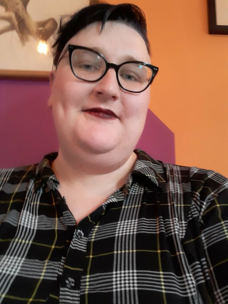 A selfie of Gretchen Felker-Martin in a plaid shirt. Photocredit Gretchen Felker-Martin via social media