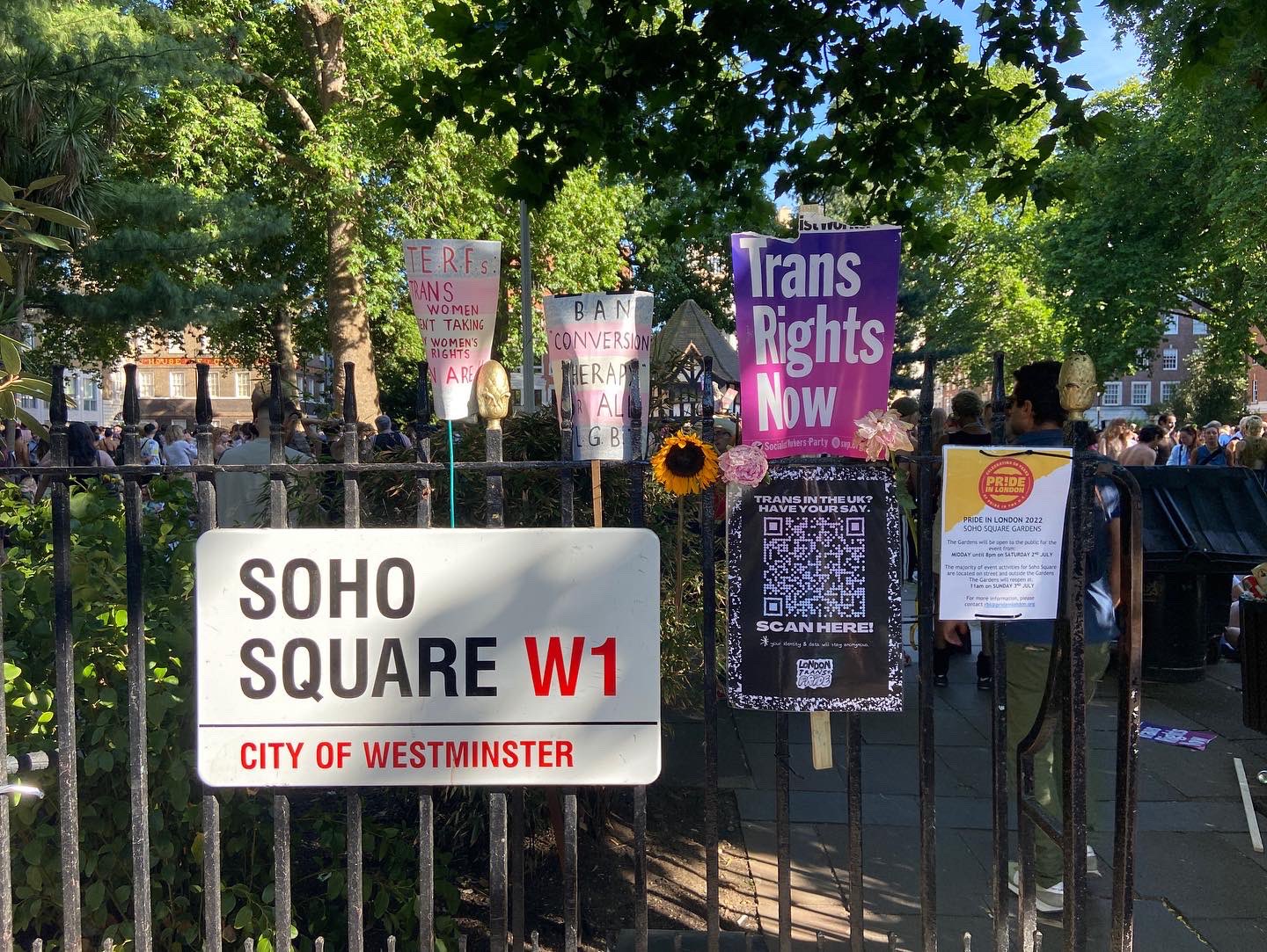 Soho Square sign surrounded by Trans Pride London signs reaching things like 