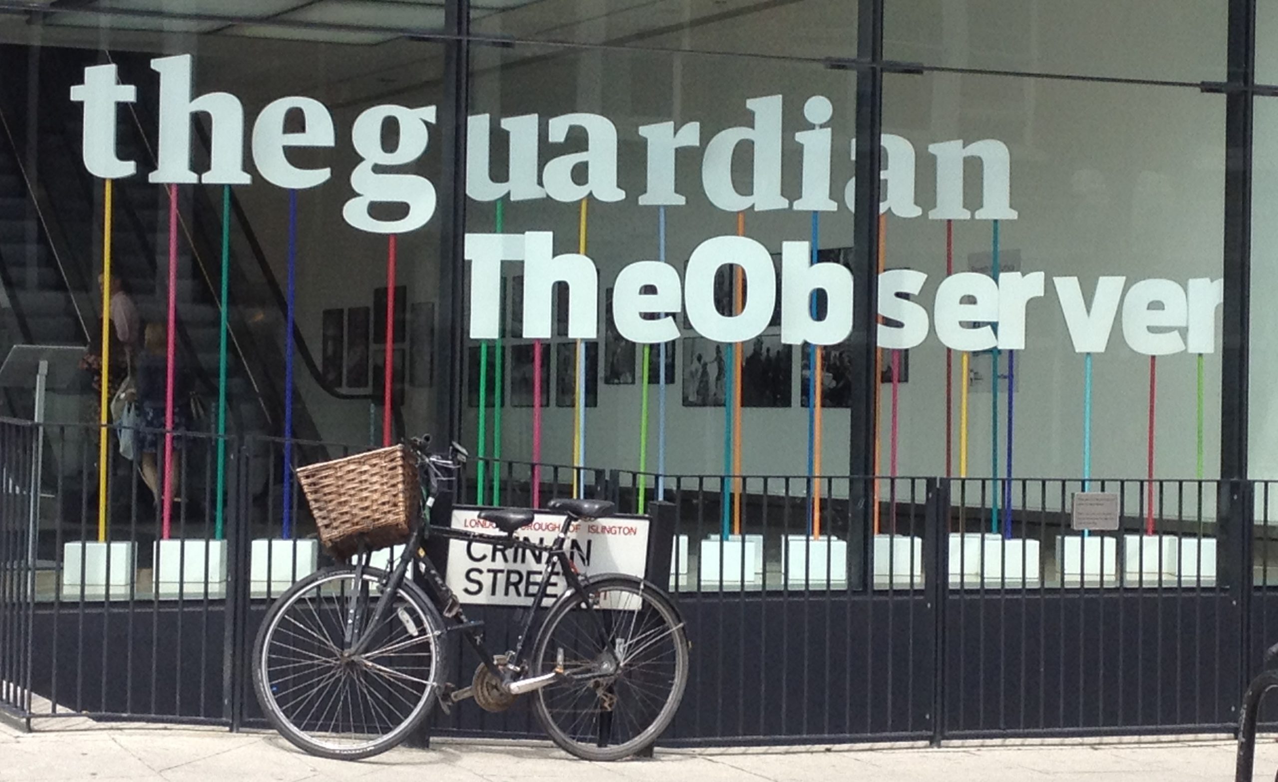 The Guardian/The Observer building in London, where Nick Cohen has been suspended from. It shows their logos in the window with a bicycle chained to the street sign out front.