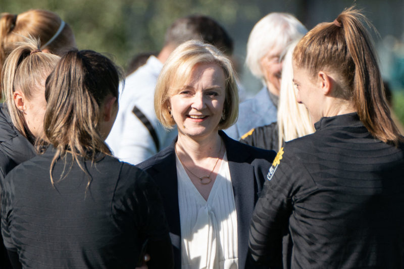 Britain's Prime Minister Liz Truss (C) meets England women's football team players during a visit at the Lensbury Resort, Teddington, south west London, on October 10, 2022 following their Euro 2022 victory in July. (Photo by Stefan Rousseau / POOL / AFP) (Photo by STEFAN ROUSSEAU/POOL/AFP via Getty Images)