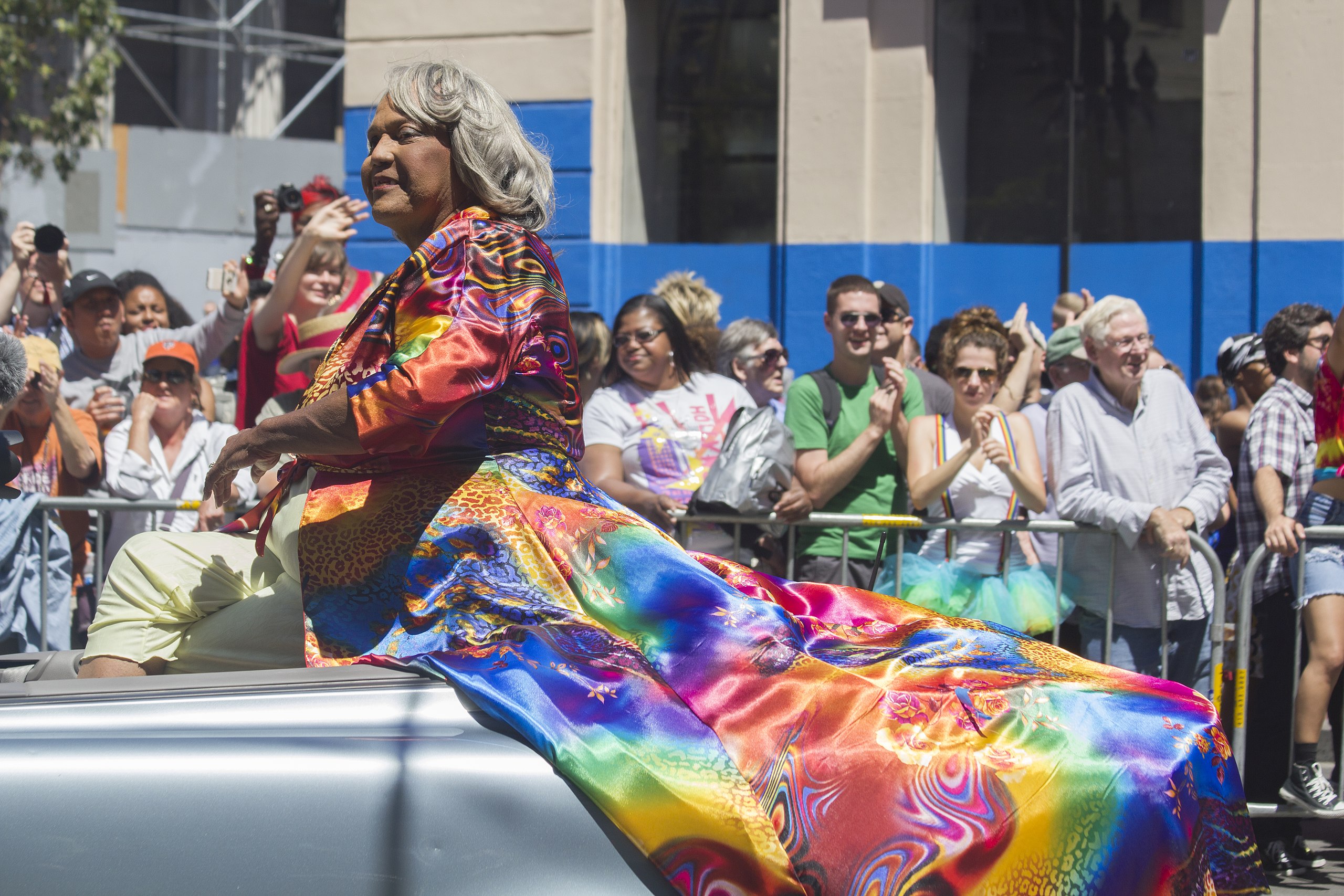 Miss Major Speaks: Miss Major Griffin-Gracy rides in the back of a convertible car adorned in rainbow patterns at San Francisco Pride in 2014