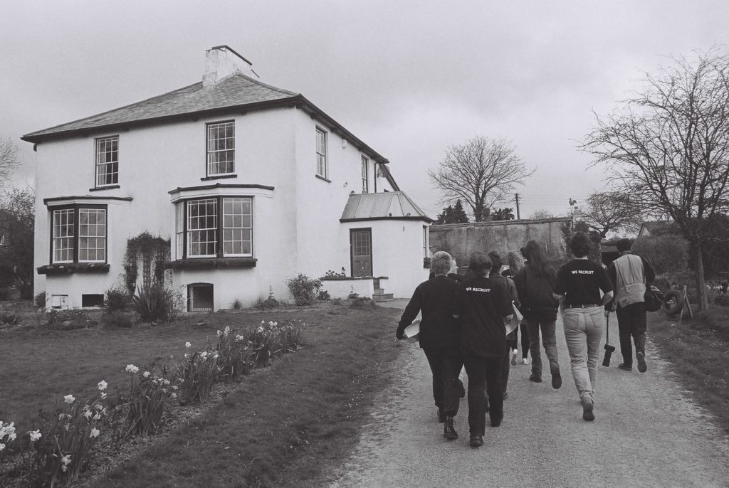 A greyscale photo of The Lesbian Avengers walking up now Baroness Emma Nicholson's driveway in Devon, 1995.