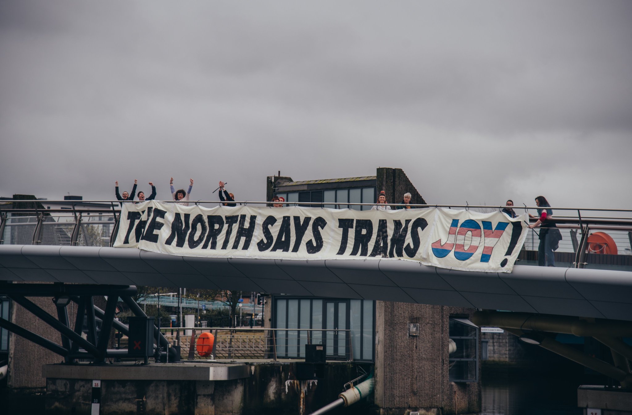 The North Says Trans Joy banner hanging behind KJK's Belfast rally, photo credit Brendan J Harkin @brendanjharkin