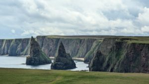 A photo of large pointed rocks called The Duncansby Stacks